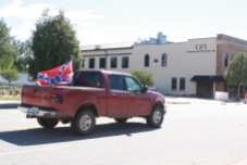 Two white males drive down Queen Street in downtown Kinston on