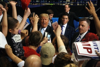 Donald Trump reacts to a crowd of supporters seeking autographs after a campaign rally in Fayetteville, N.C. on March 9, 2016.